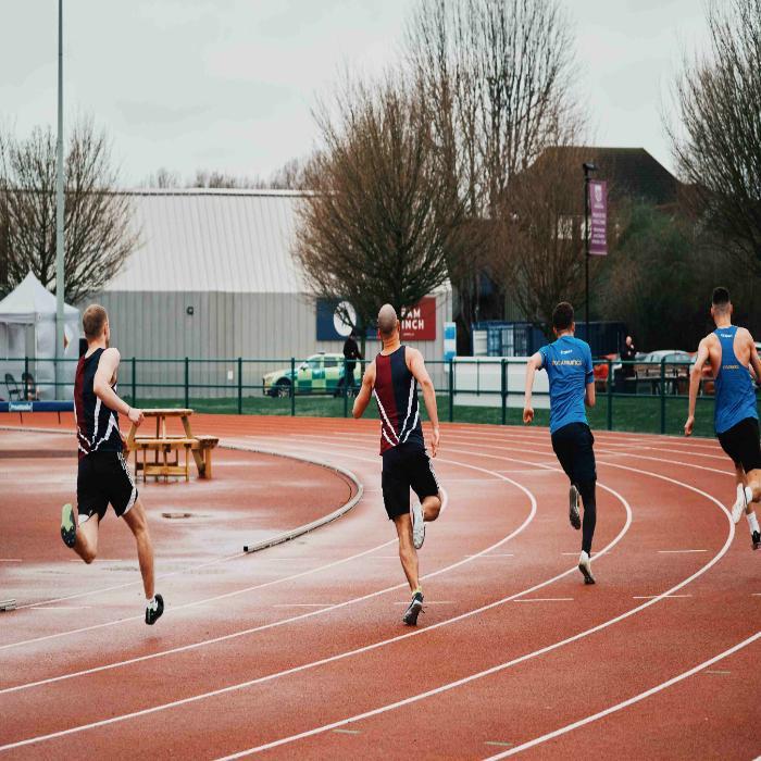 five runners on an athletics track