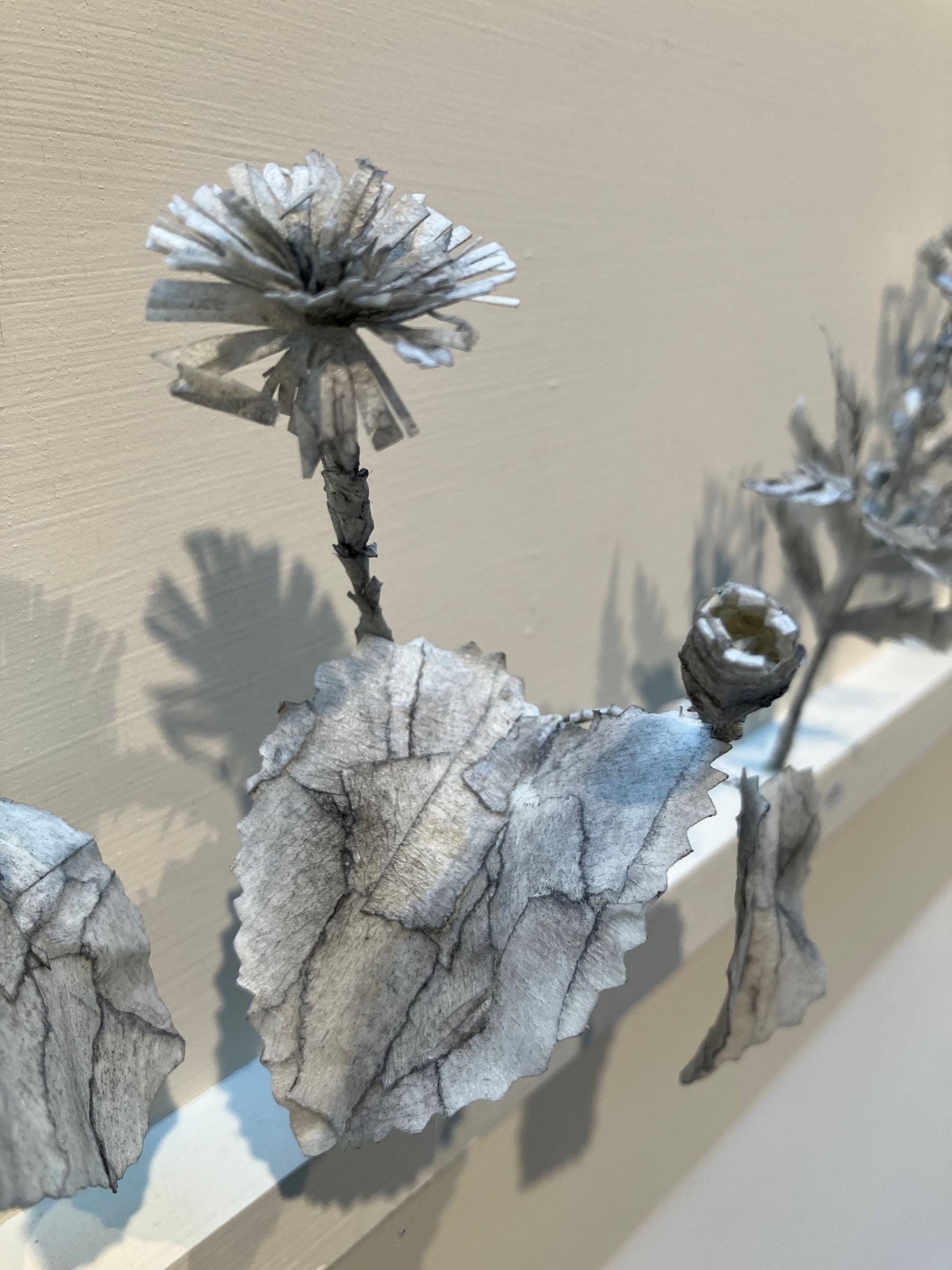 A small grey flower sculpture
