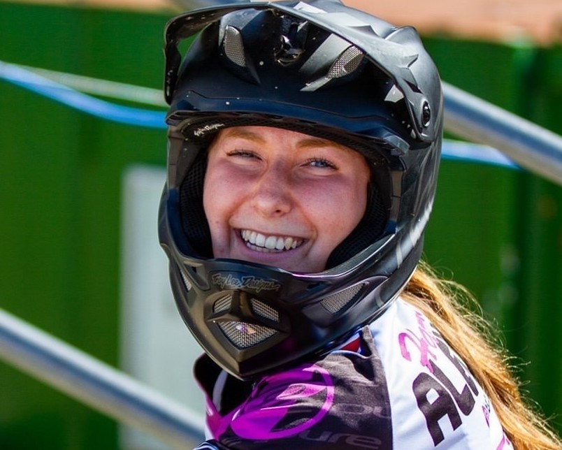 Smiling girl BMX rider in helmet