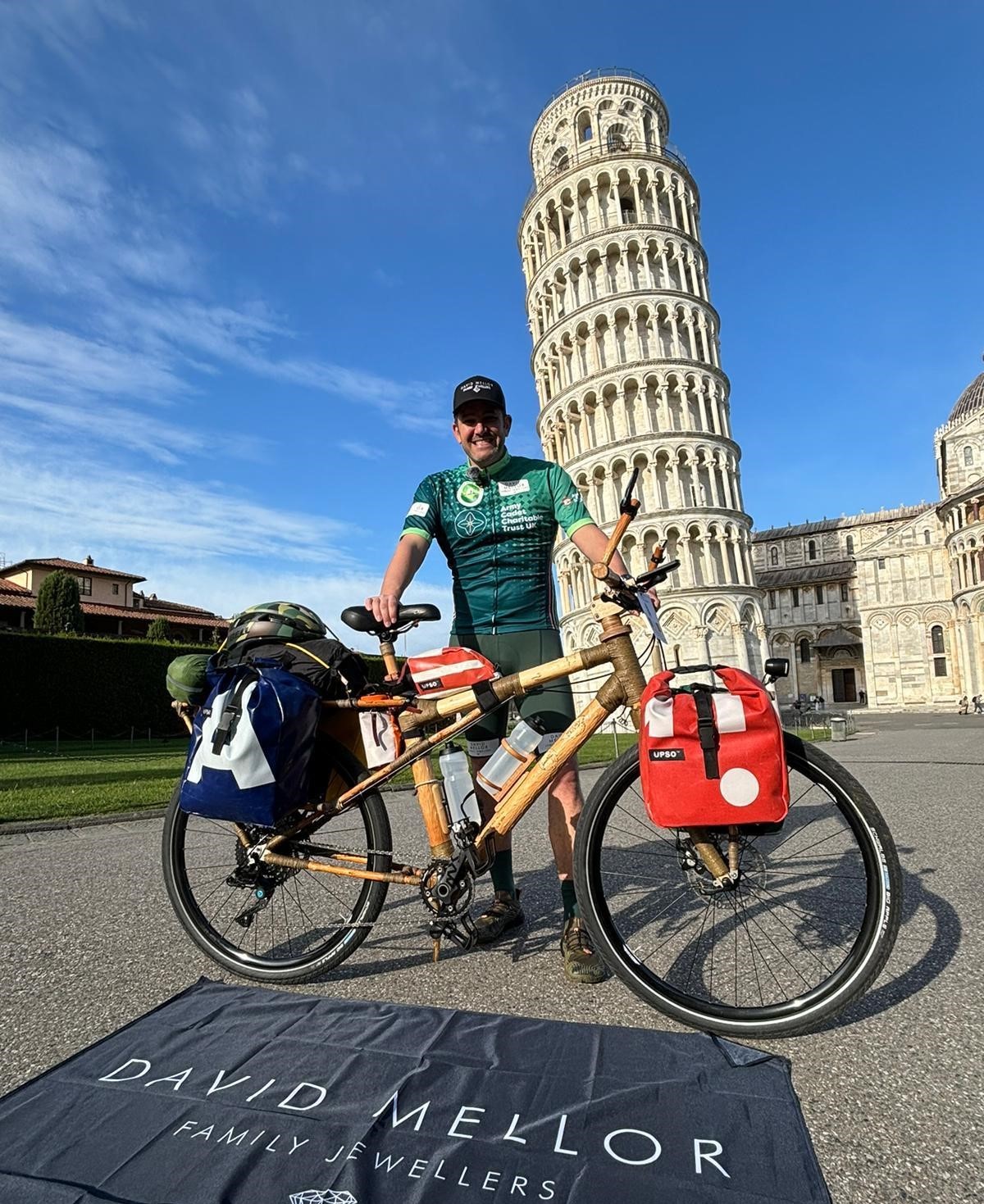 Cyclist in front of Leaning Tower of Pisa