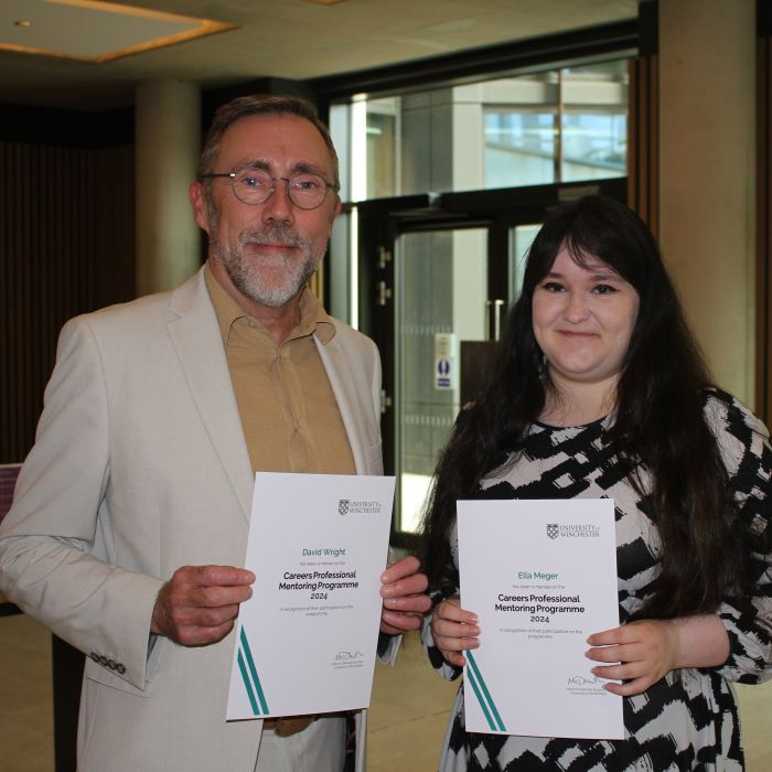 Man and woman holding certificates