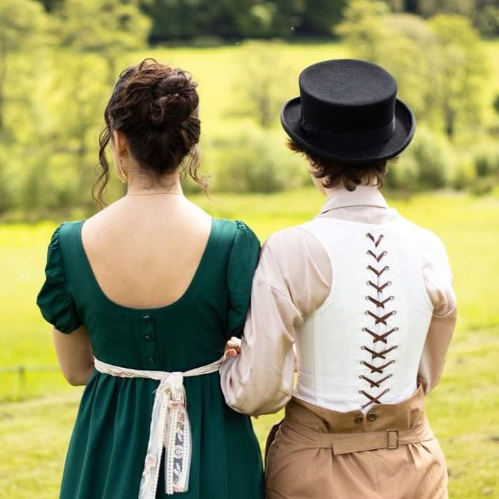 View of the backs of a regency couple standing arm in arm