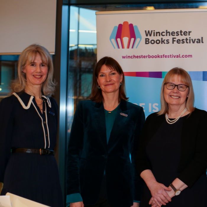 Three women in front of banner saying Winchester Books Festival