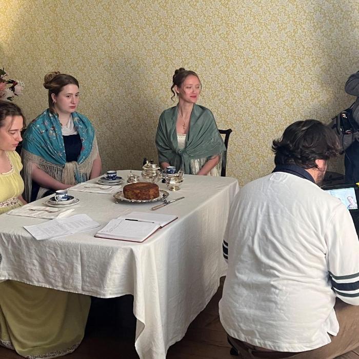 film set with people sat at a table