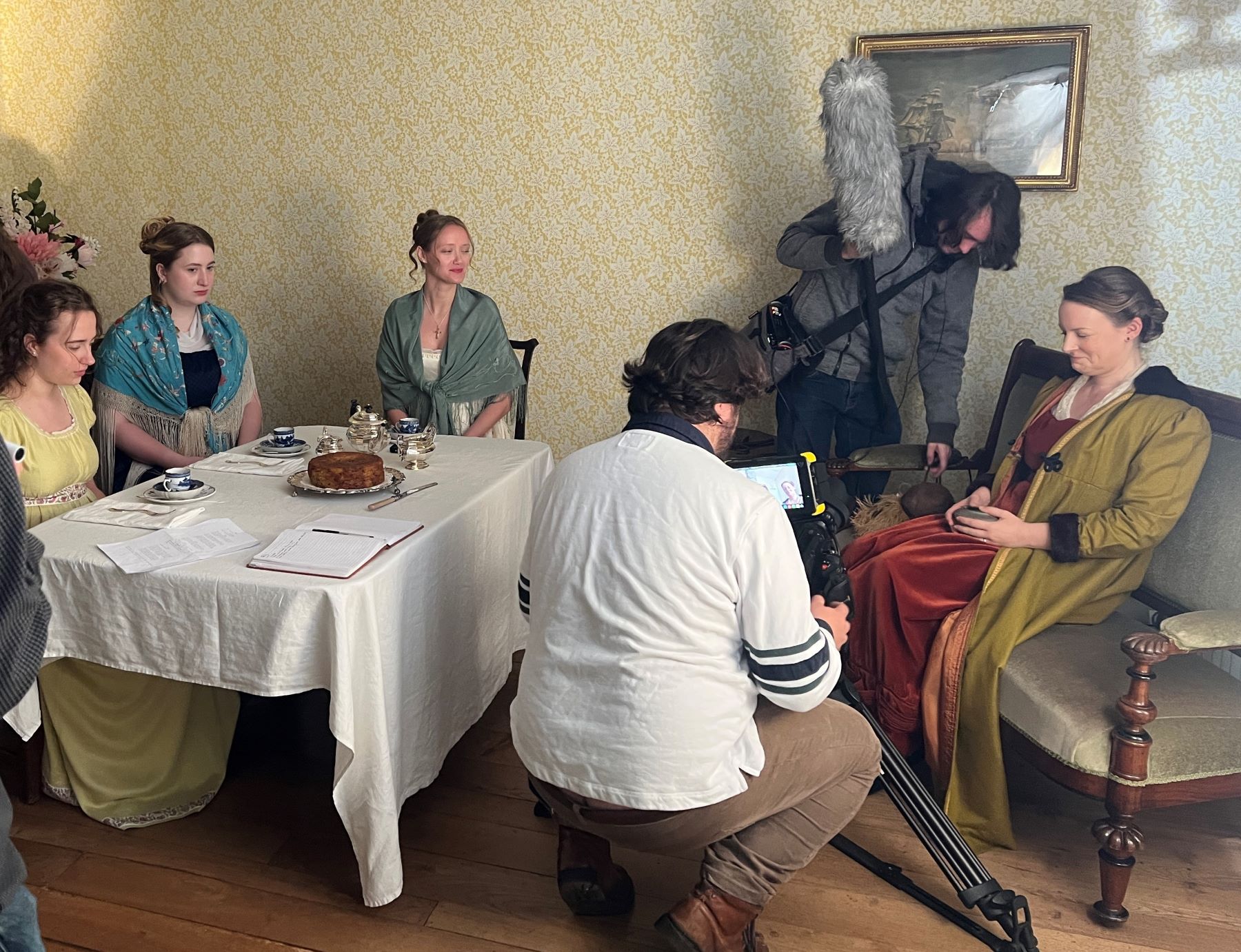 film set with people sat at a table
