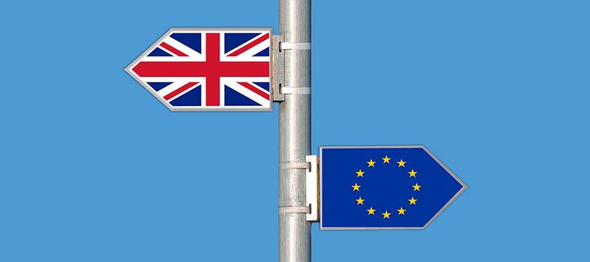 UK and EU Flags displayed as opposing directions on a signpost