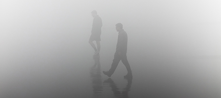 People walking in mist