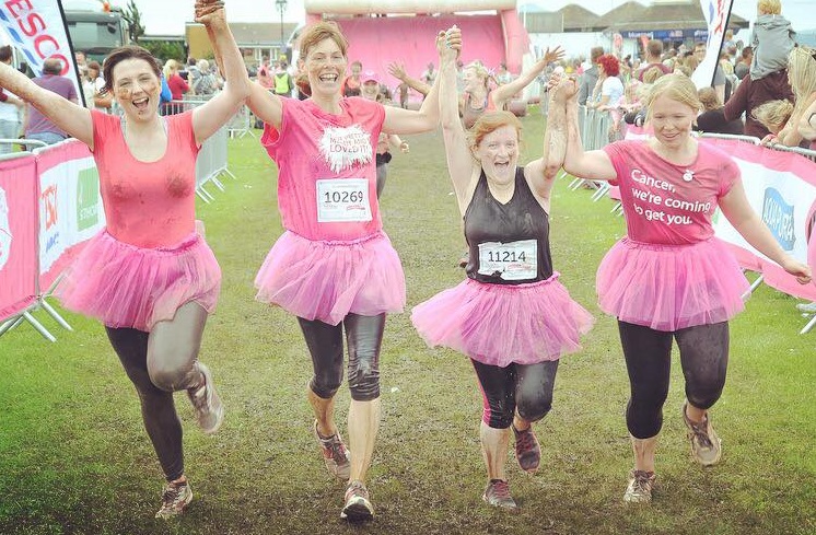 Four women in pink tutu's running Winchester Half Marathon