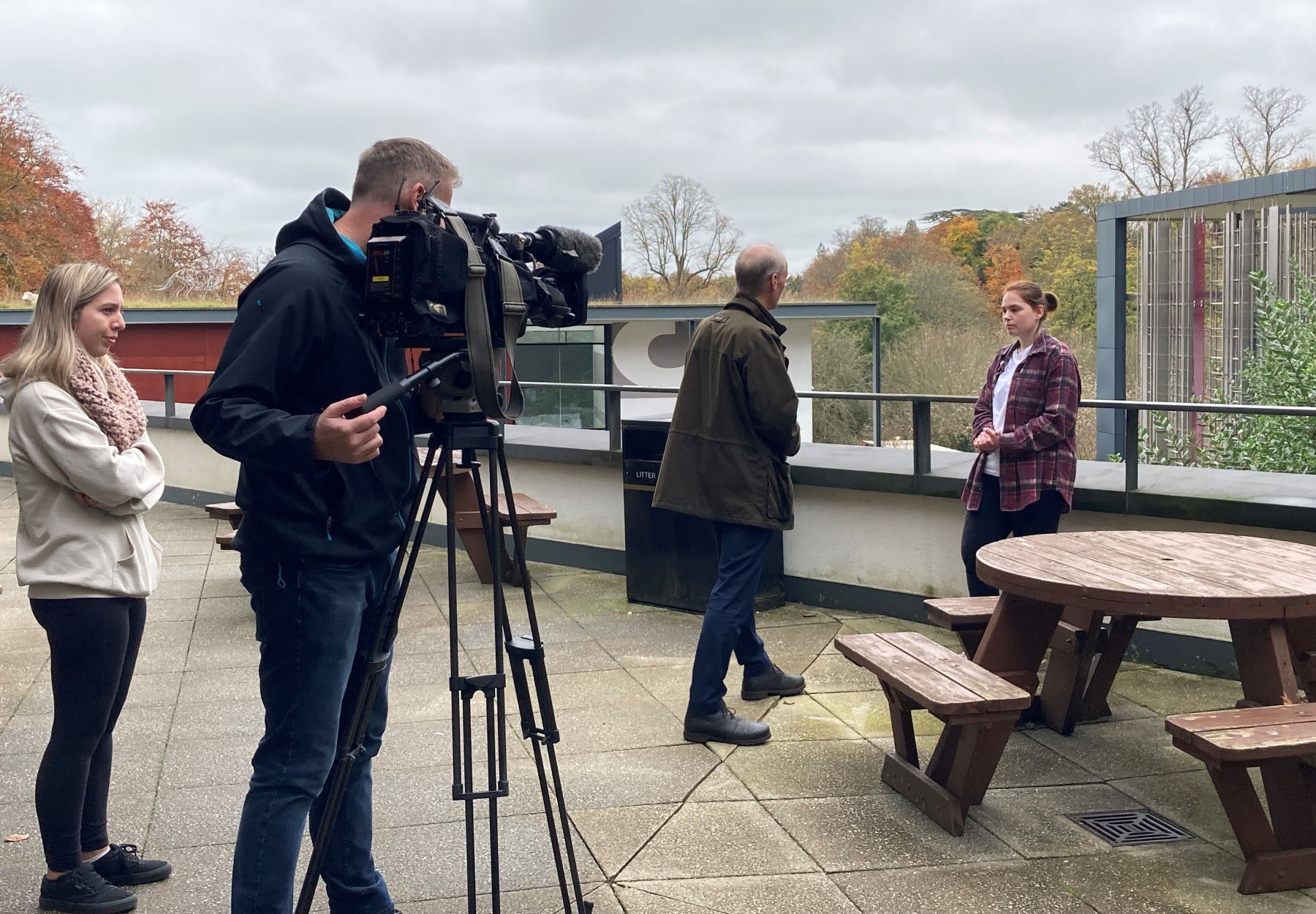 Young woman talking to TV news crew