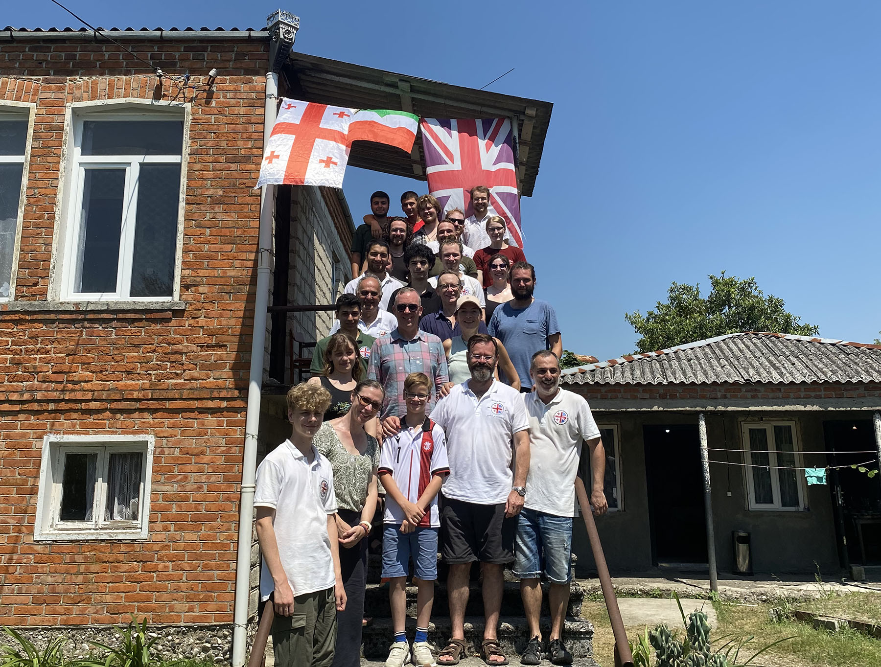 A group of people standing underneath international flags