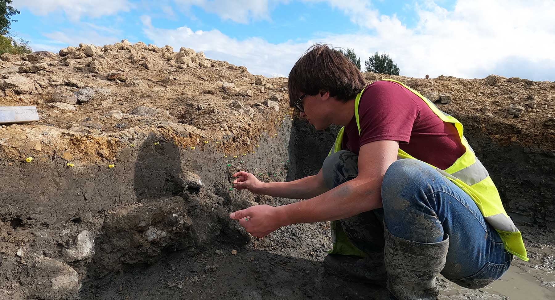 University of Winchester Archaeology student marking stratigraphic boundaries with coloured pins