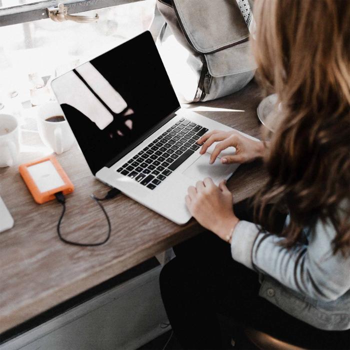 woman with long hair working on laptop