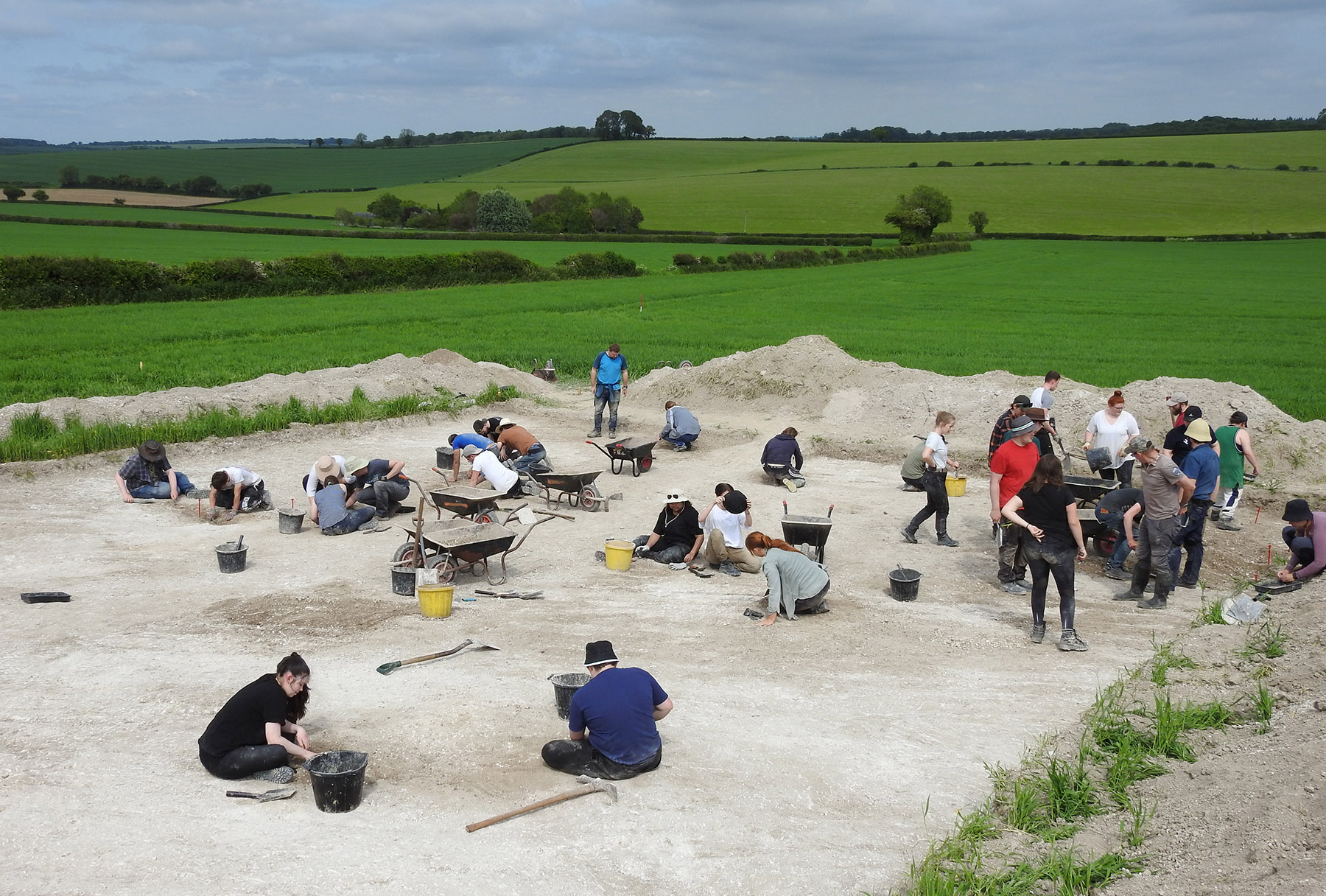 Aerial view of an archaeological excavation trench in the wider landscape