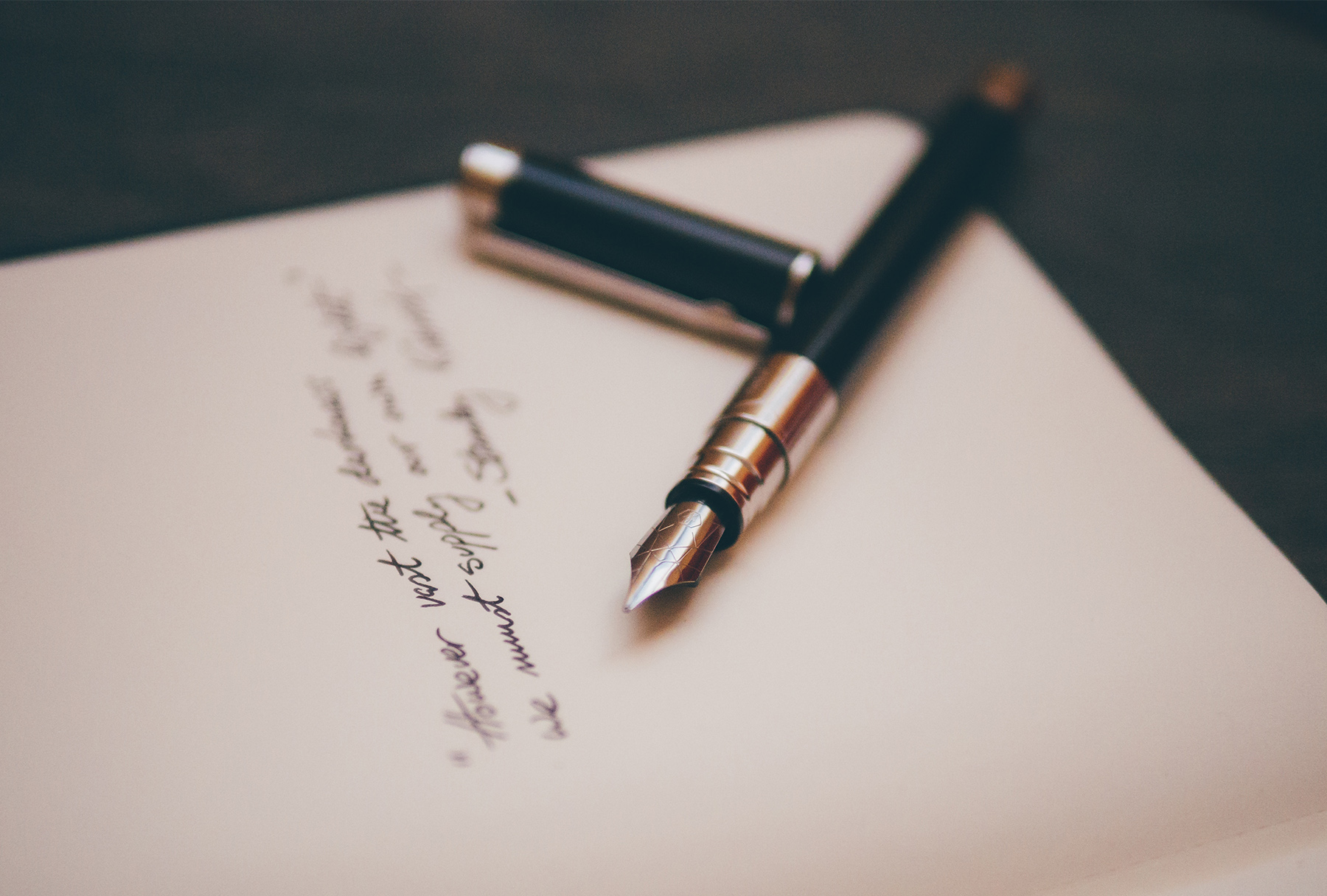 Handwritten note with a fountain pen beside