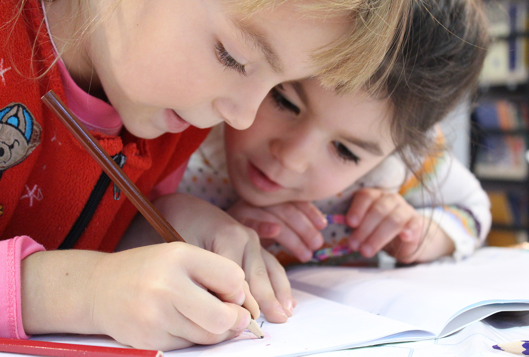 Two children looking at writing on a piece of paper