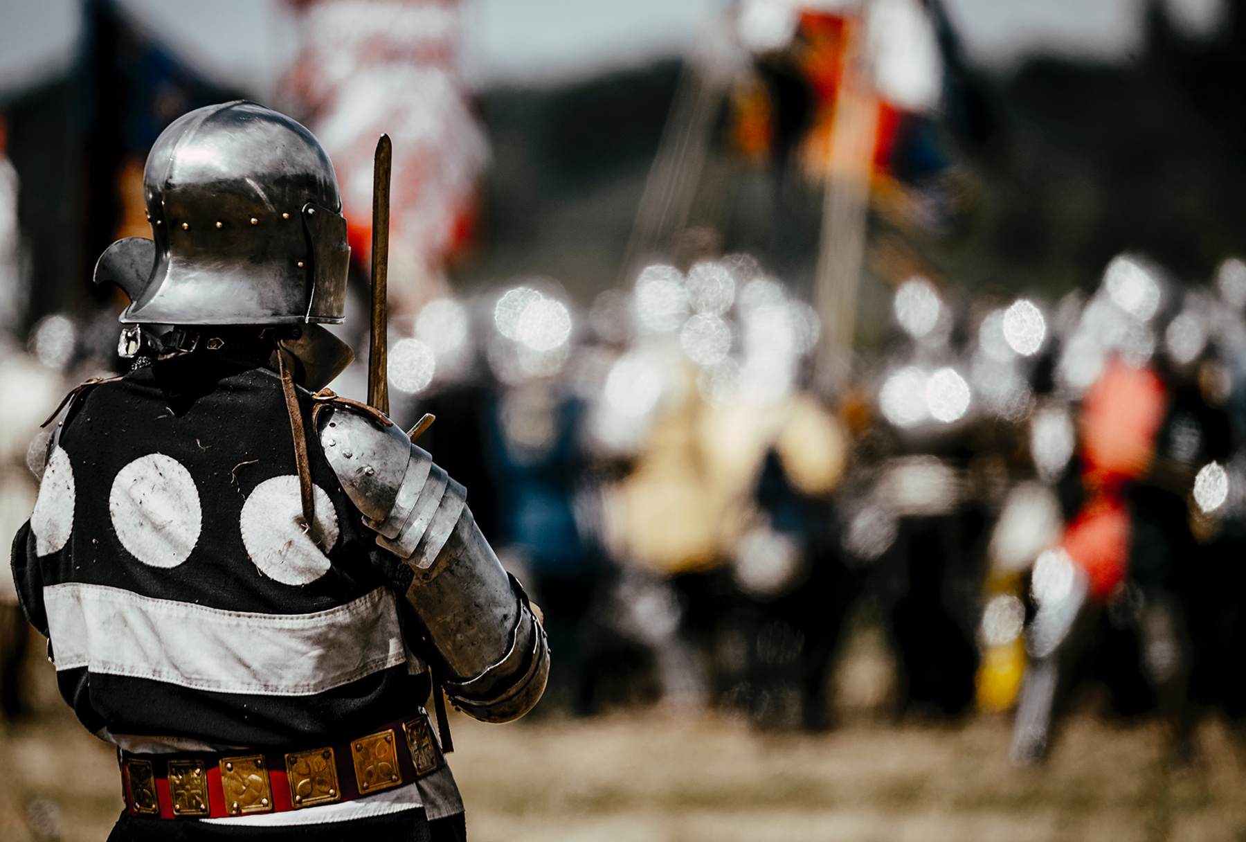 Person in armour looking across to a group