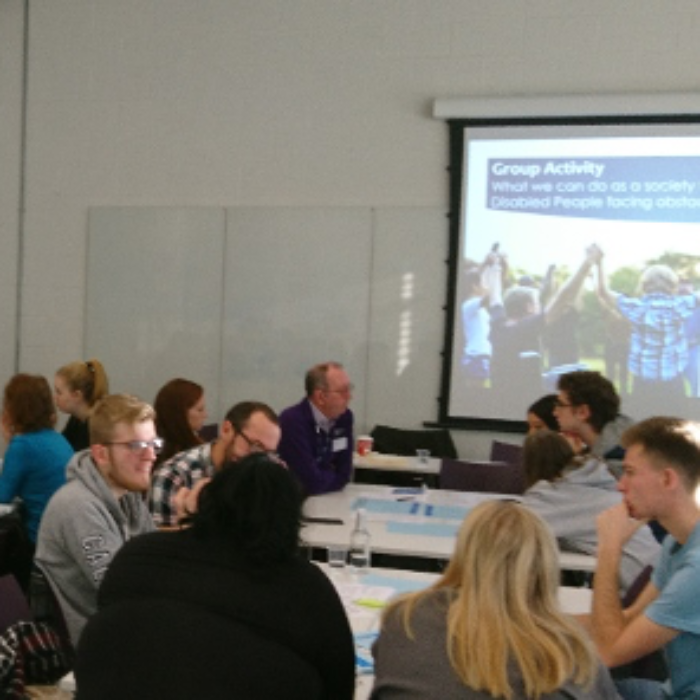 Disability professional lecturing sociology students