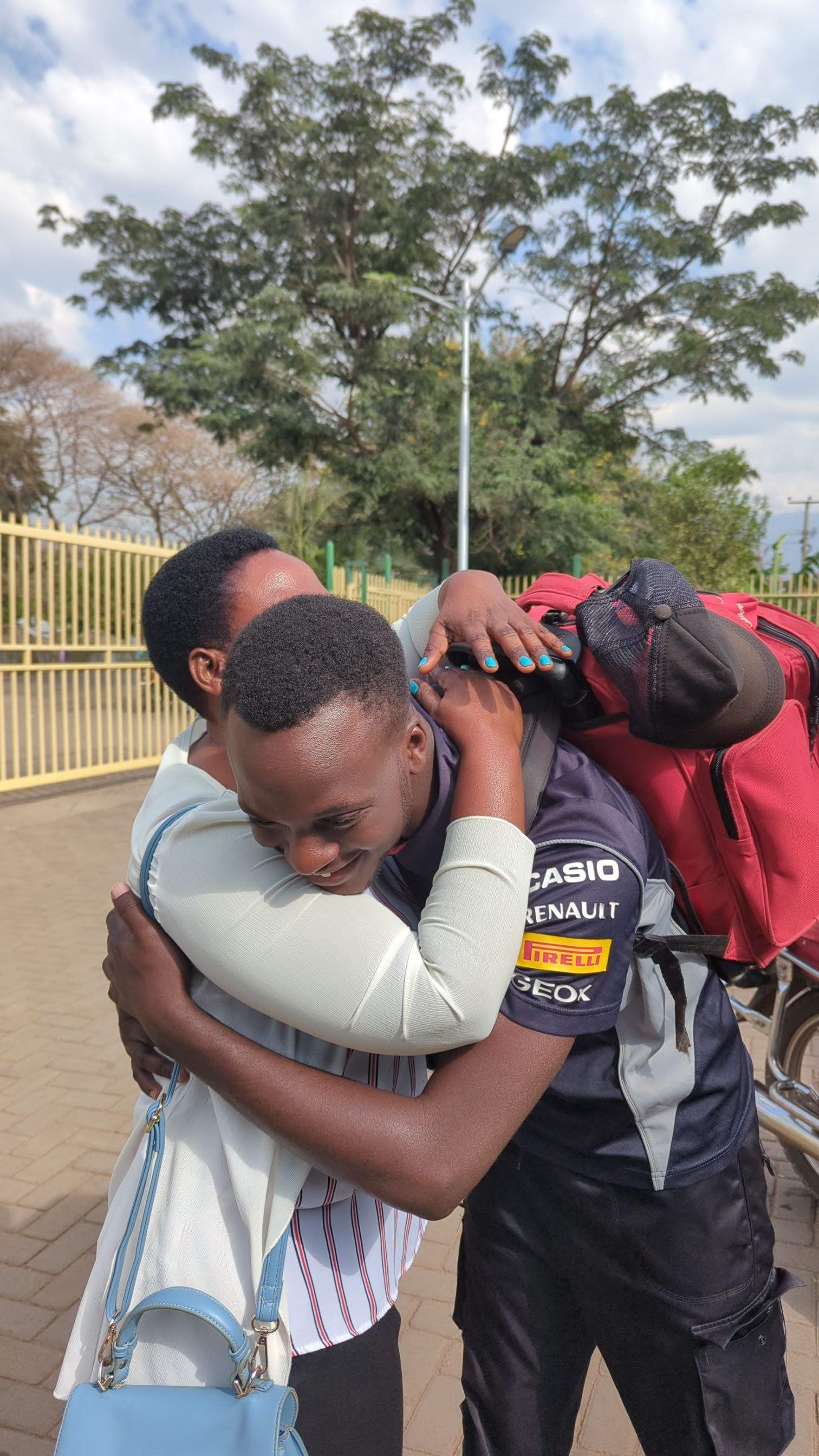 Thomas Bwambale Muhiwa hugs his mother in Uganda