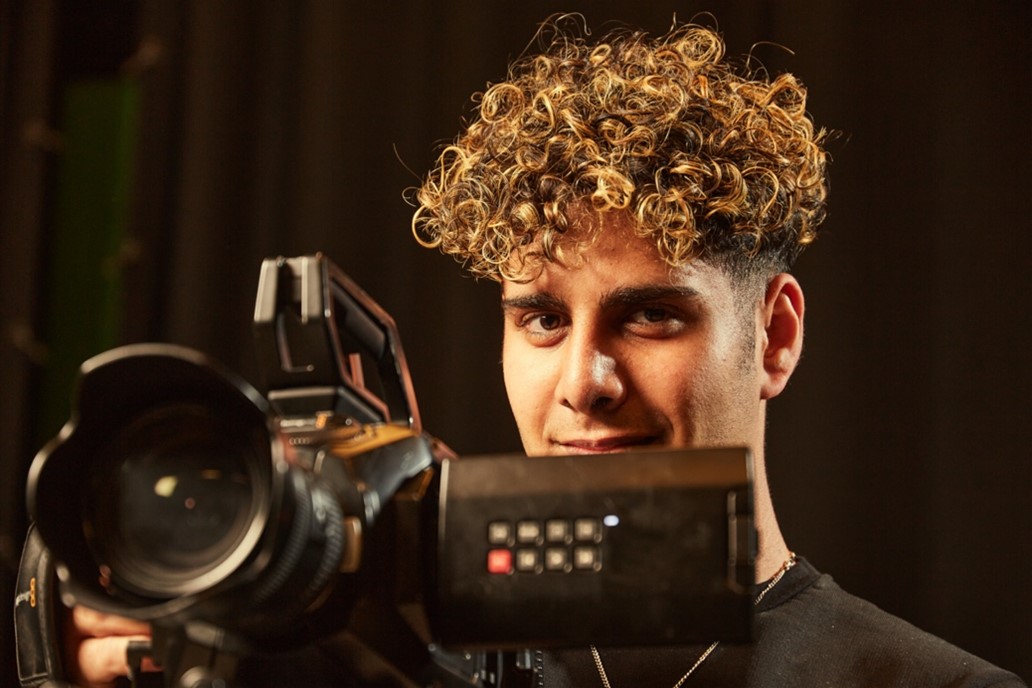 A student behind a video camera