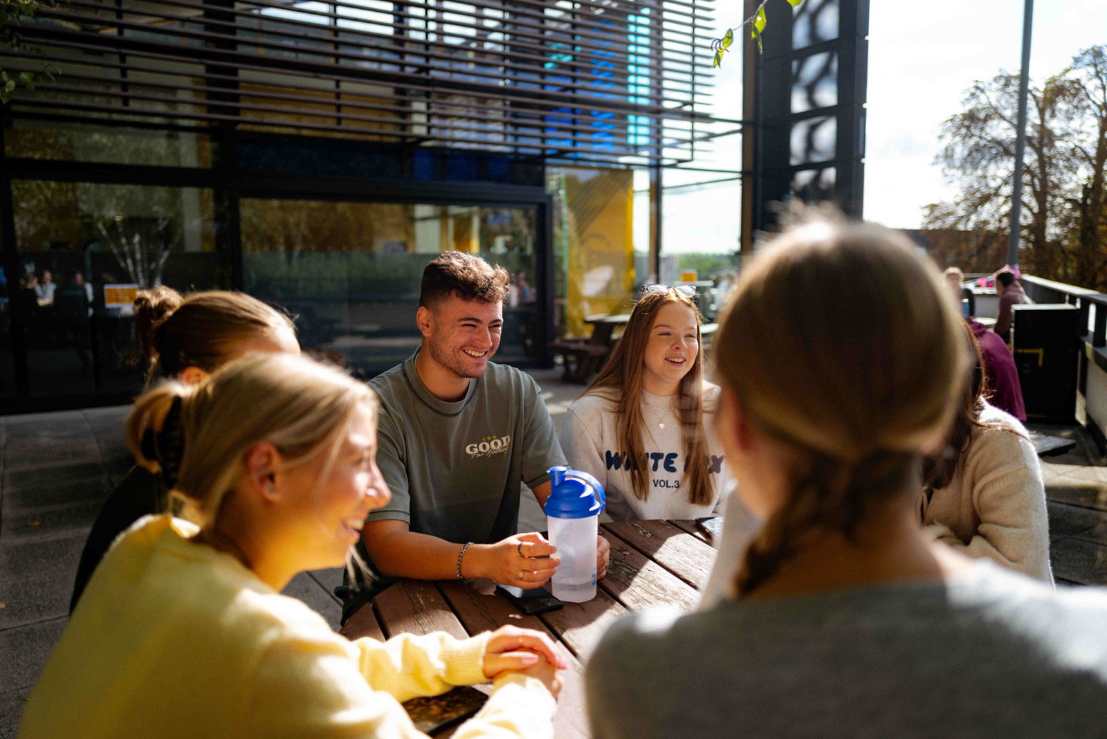Students sat outside in the sun