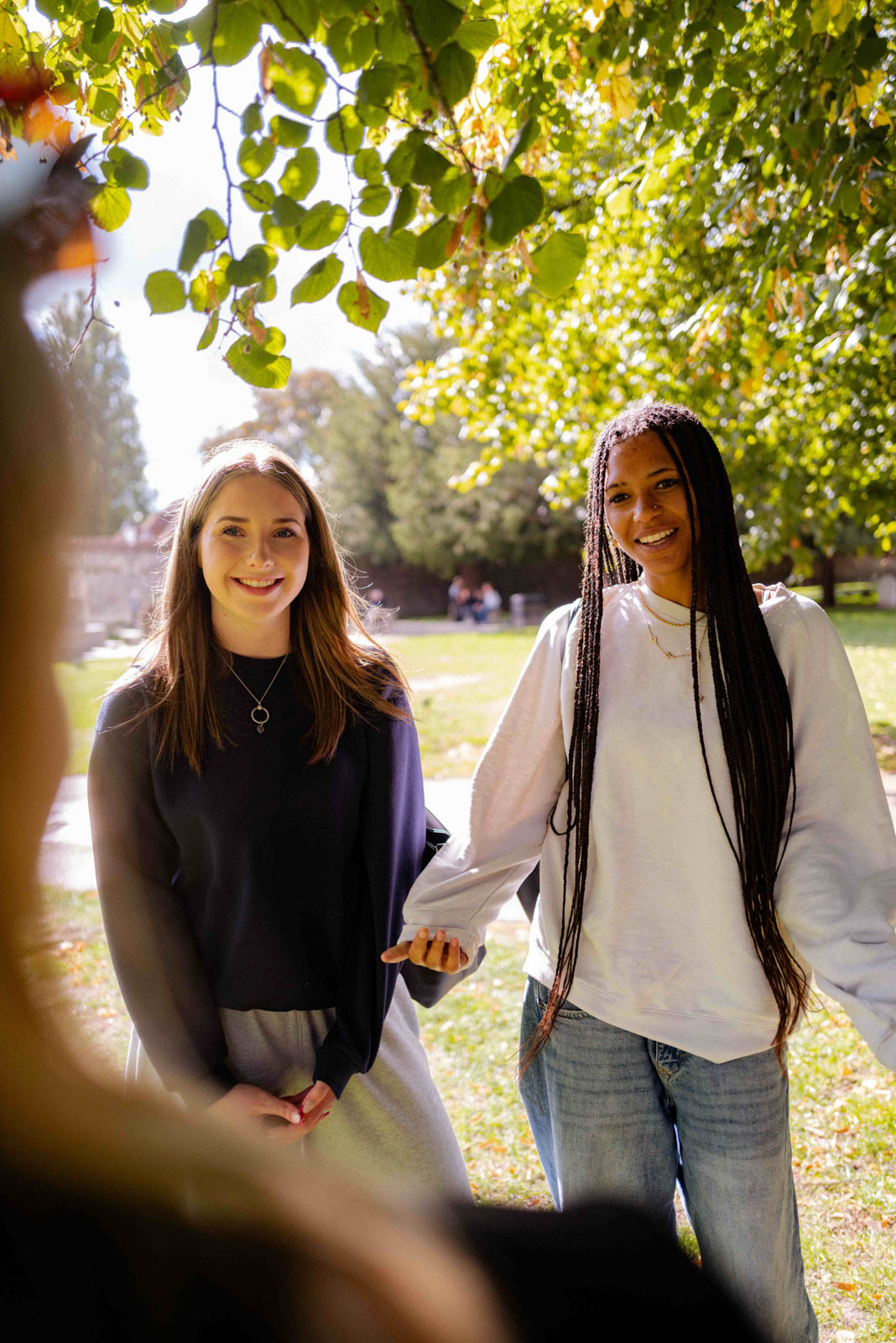 Two students chat outside Winchester Cathedral