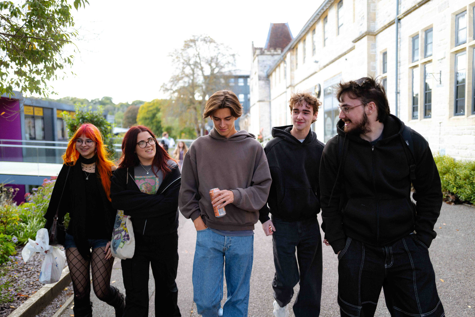 A group of students walk through the campus