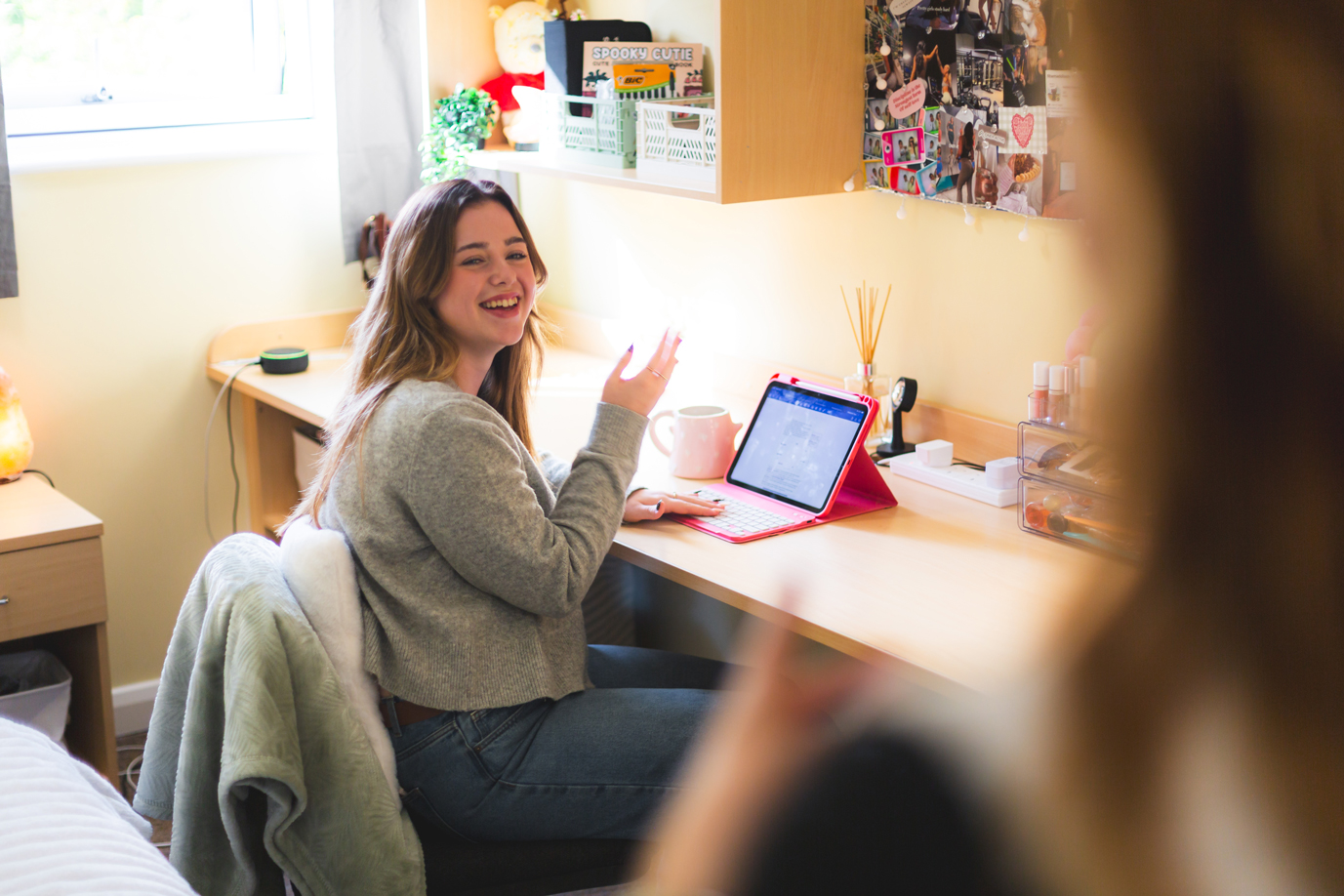 A student studies in her room