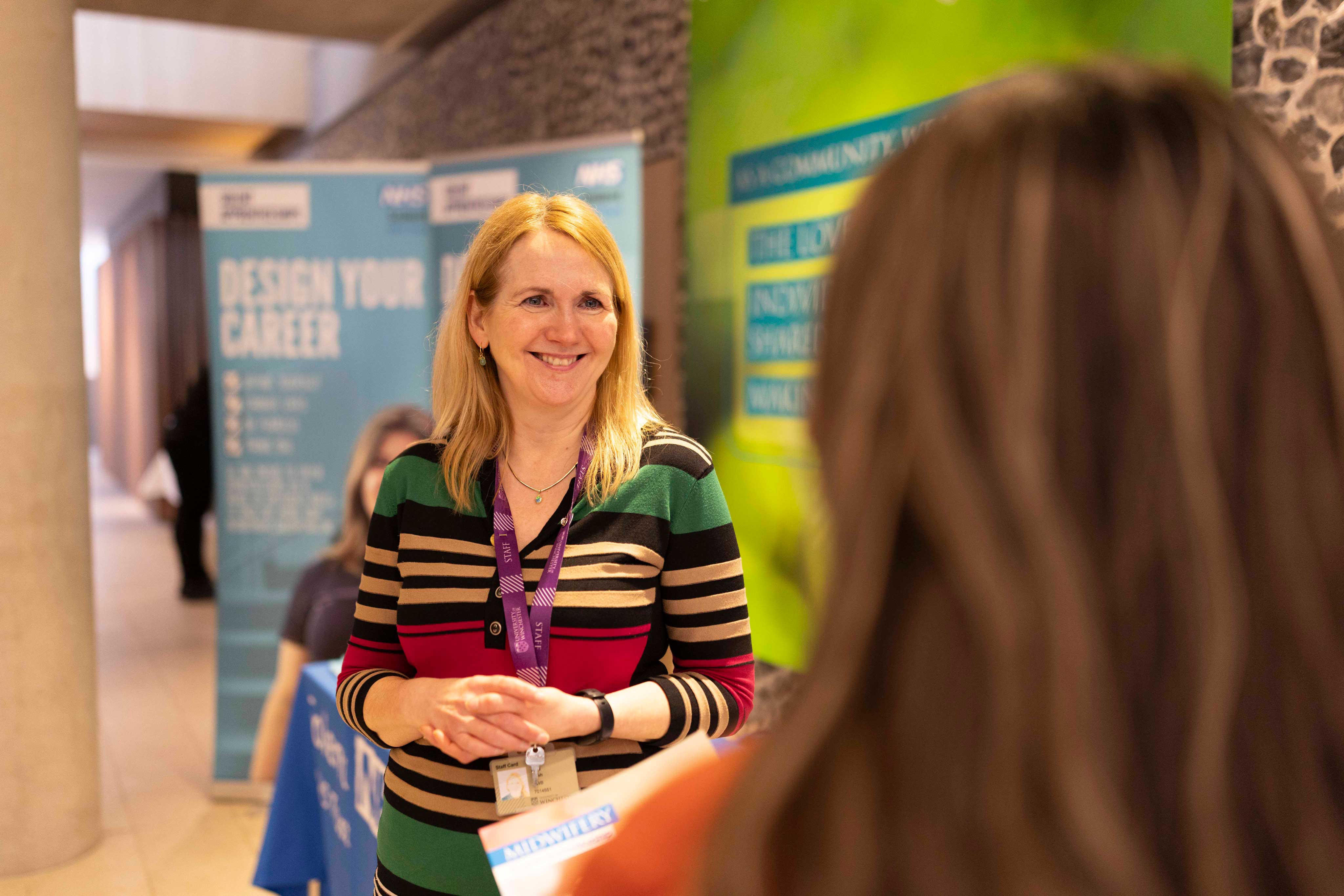 A member of staff talks to a student