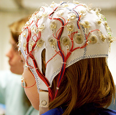 Someone wearing a hat measuring brain activity