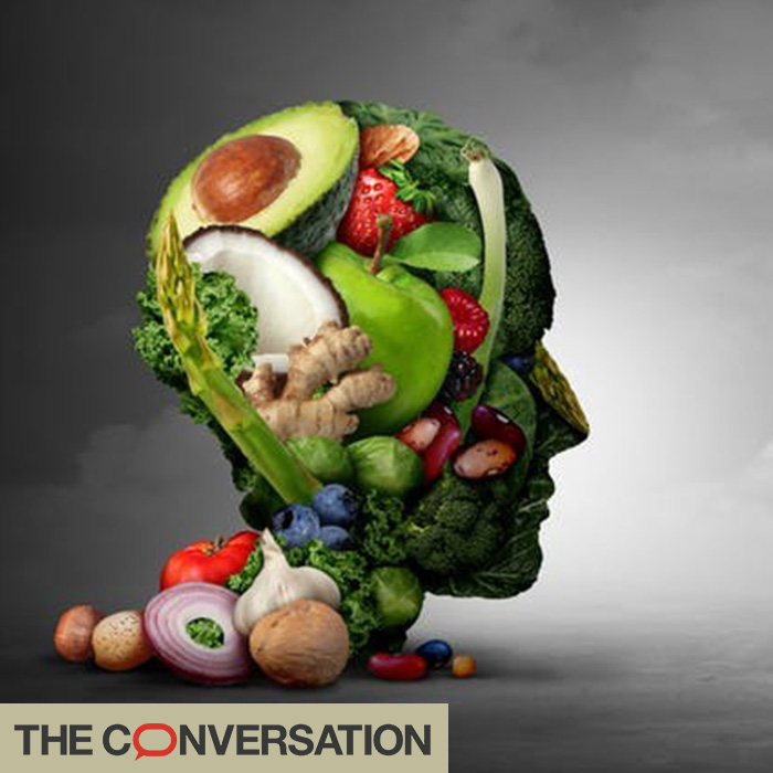 Model of a head made out of fresh fruit and vegetables