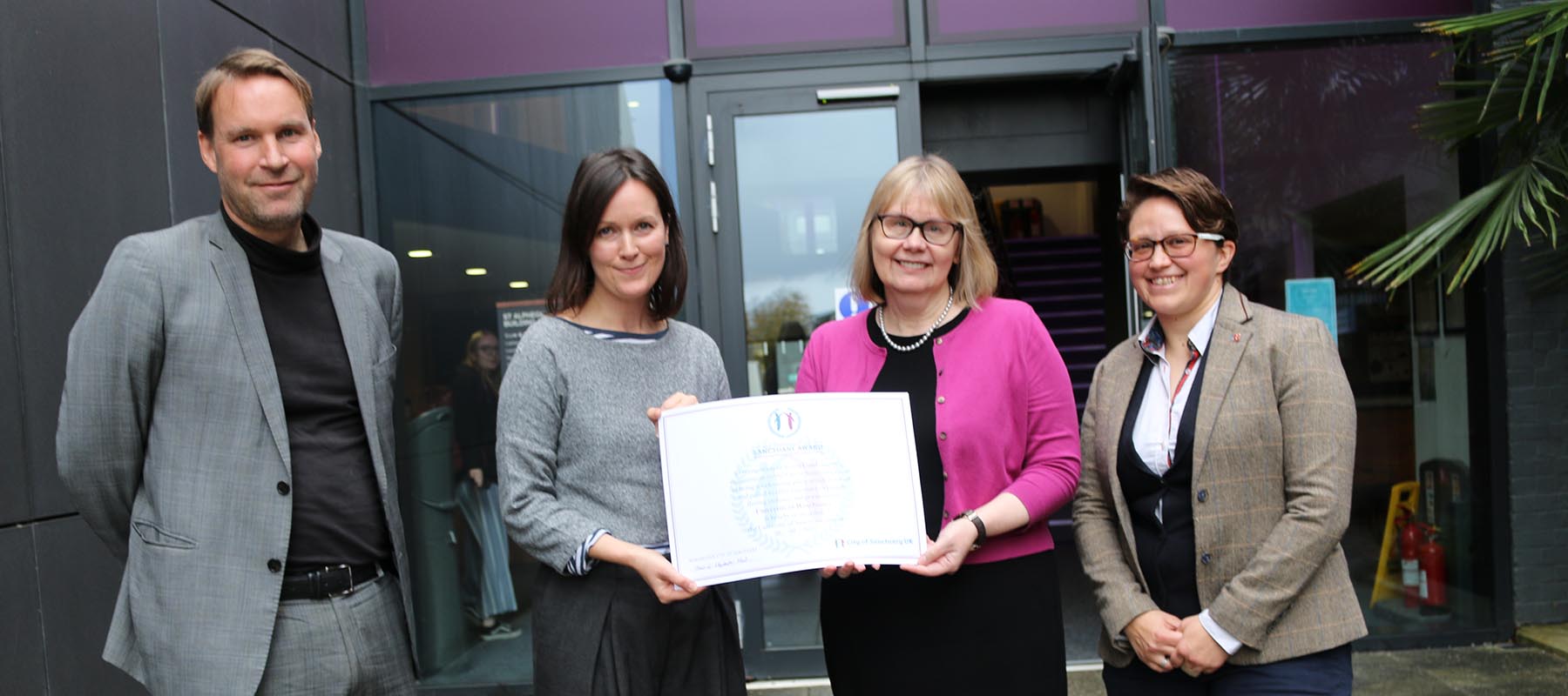 Joy Carter and Nicola Walters standing with University of Sanctuary certificate
