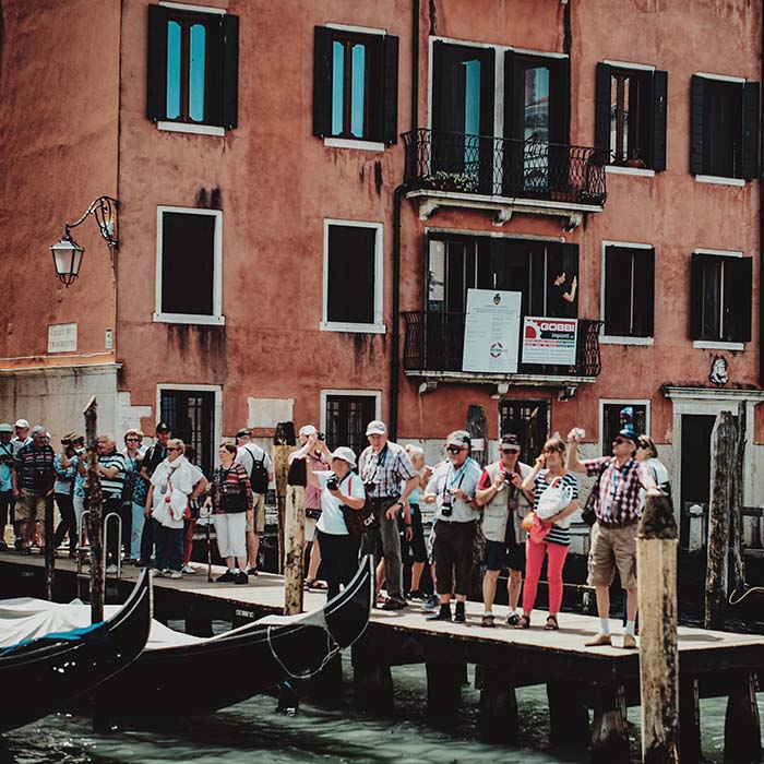 Tourists by a canal in Venice