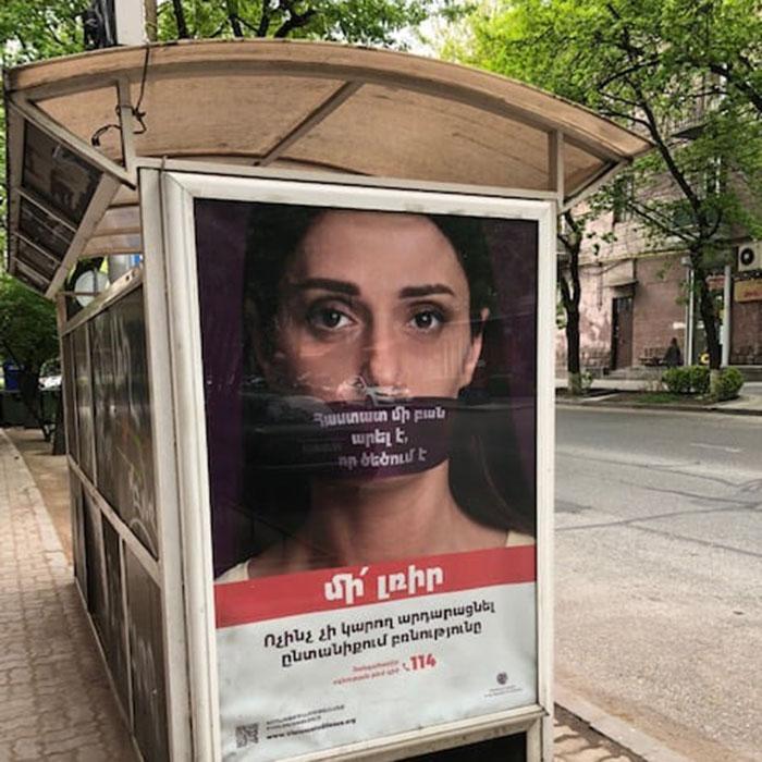Poster of woman's face on side of bus shelter