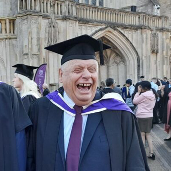 Mike Cranston outside Winchester Cathedral with his son Paul at their Graduation