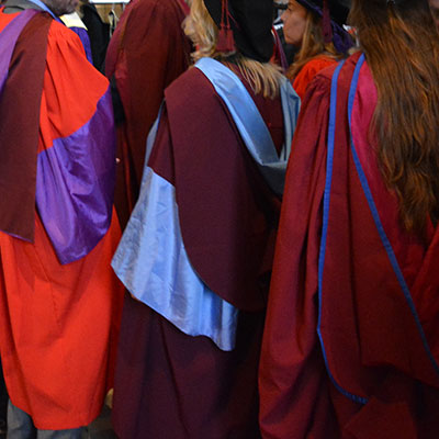 Postgraduate research degrees st Winchester: graduating PhD students in Winchester Cathedral in their academic robes