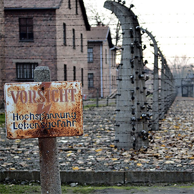 Auschwitz WWII concentration camp with barbed wire and barracks