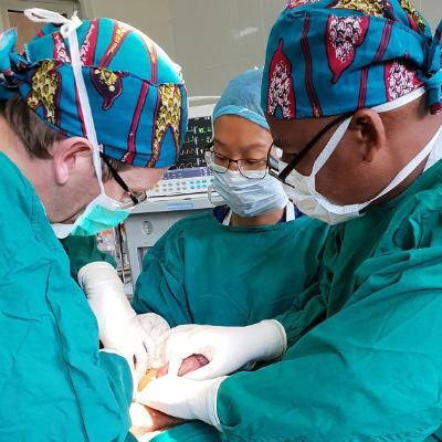 Global Health collaboration at the University of Winchester: three surgeons in an operating theatre in Tanzania