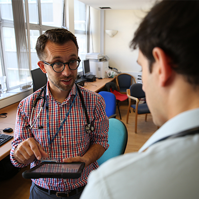 Medical education at Winchester: two men talking, one wearing a stethoscope
