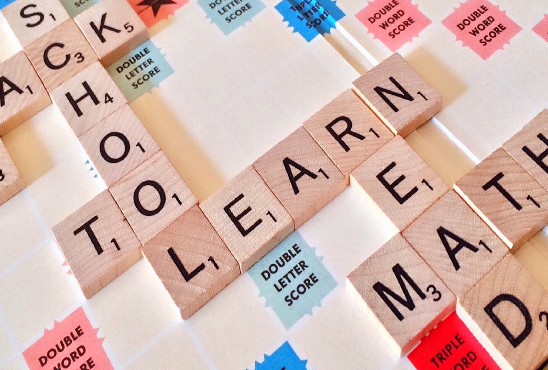 Scrabble board with the words School, Learn and Math