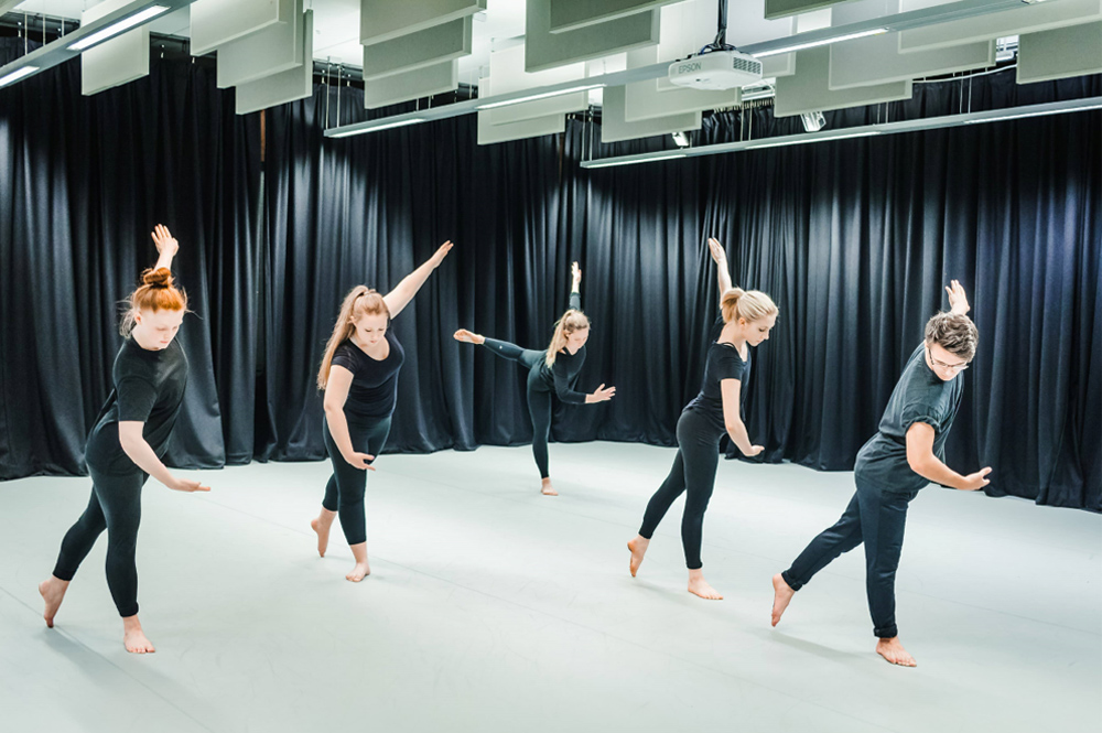 Group of five students dancing in a performance studio