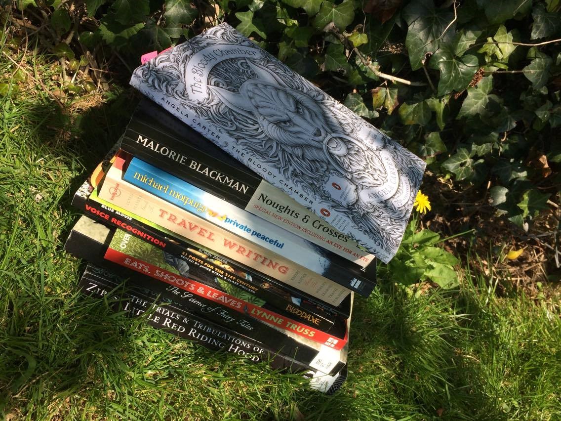 Pile of books on grass outdoors