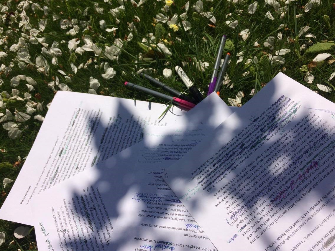 Notes and pens in the grass